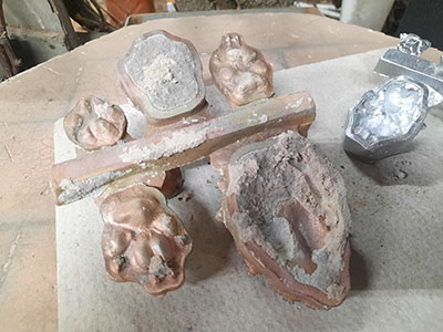 bronze paw castings still on gating system