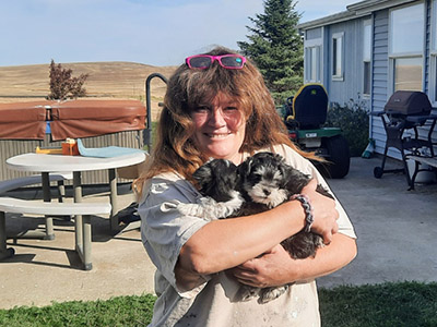 Tracy the artist holding puppies